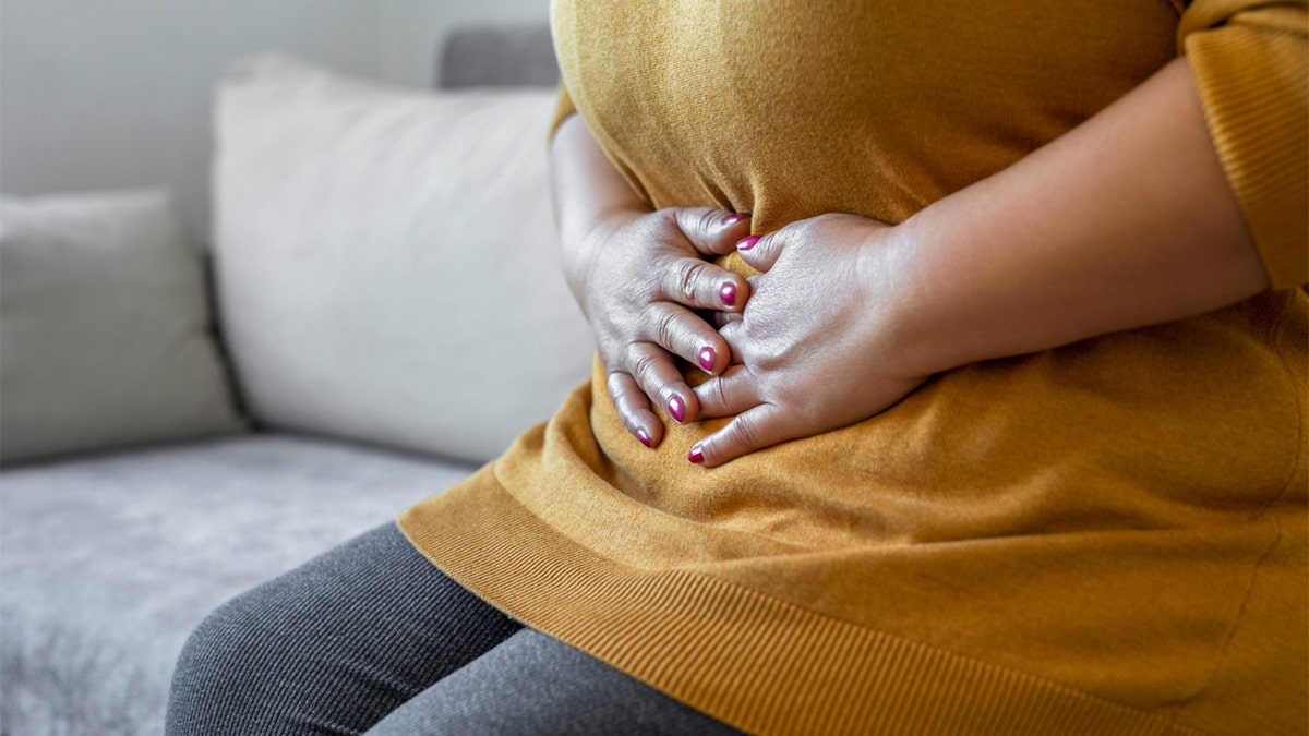 A woman holding her stomach